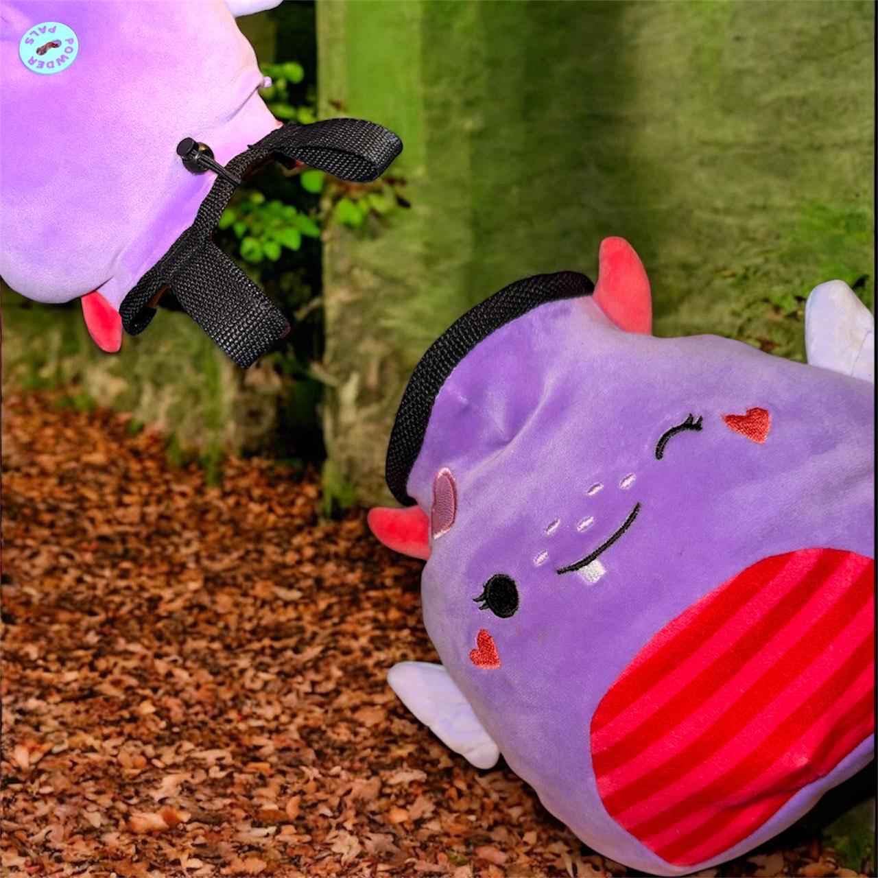 Purple Chalk bag handmade converted plush toy with devil horns, wings, and a red tail on a nature background squishmallow powder pals badge