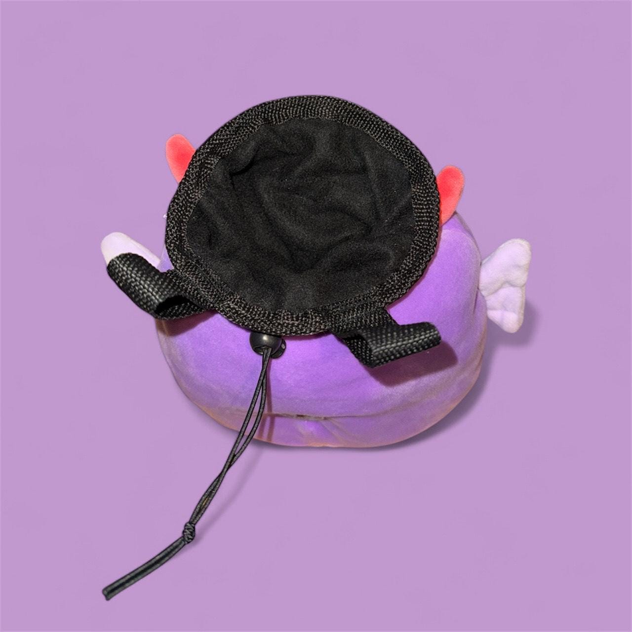 Purple Chalk bag handmade converted plush toy with devil horns, wings, and a red tail on a purple background squishmallow top down view