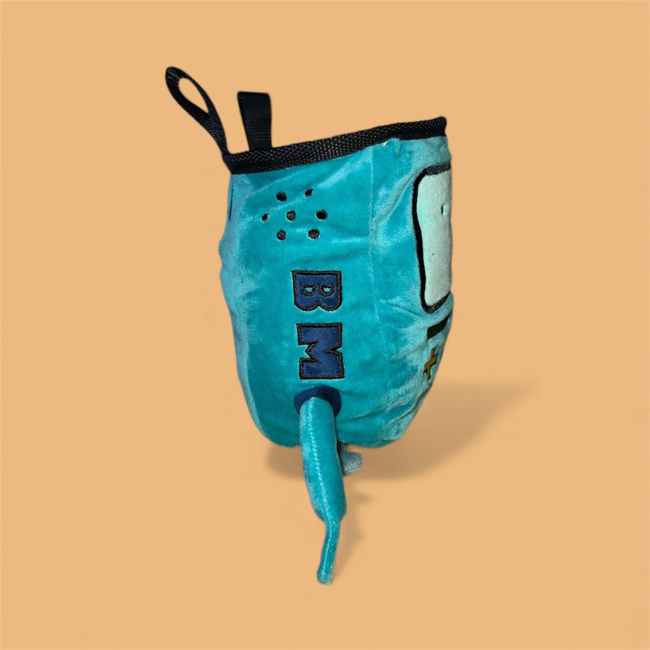 Handmade BMO plush chalk bag for bouldering on orange background side profile