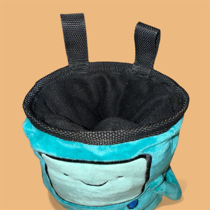 Handmade BMO plush chalk bag for bouldering on orange background close up
