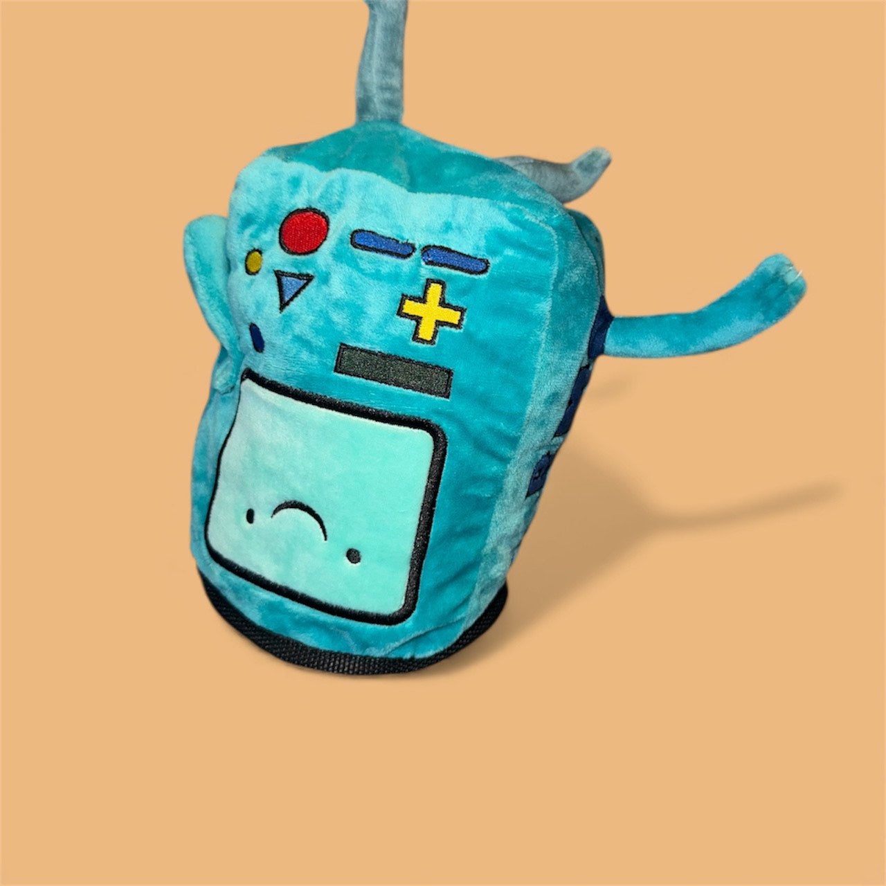 Handmade BMO plush chalk bag for bouldering on orange background upside down