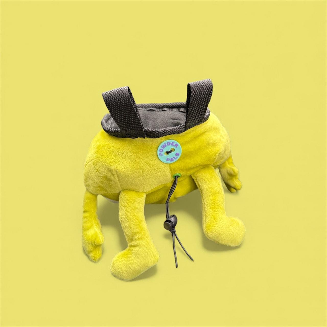 Handmade Bing Bong plush chalk bag for bouldering on green background back profile with "Powder Pals" button logo